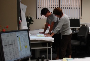 Chrystal and Nicolas Yamasaki reviewing plans in the Kailua-Kona office